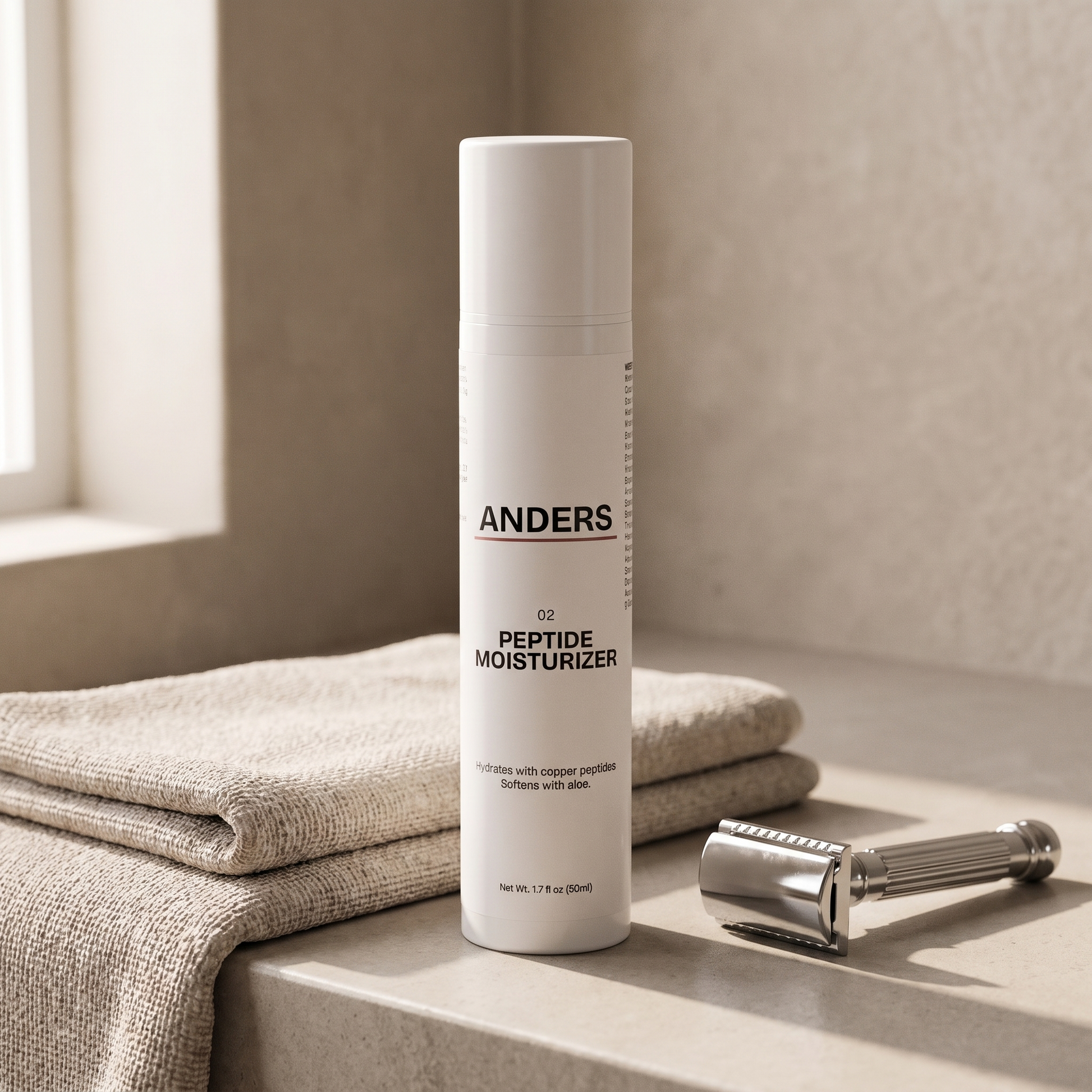 ANDERS Peptide Moisturizer on a bathroom counter beside a folded towel and safety razor