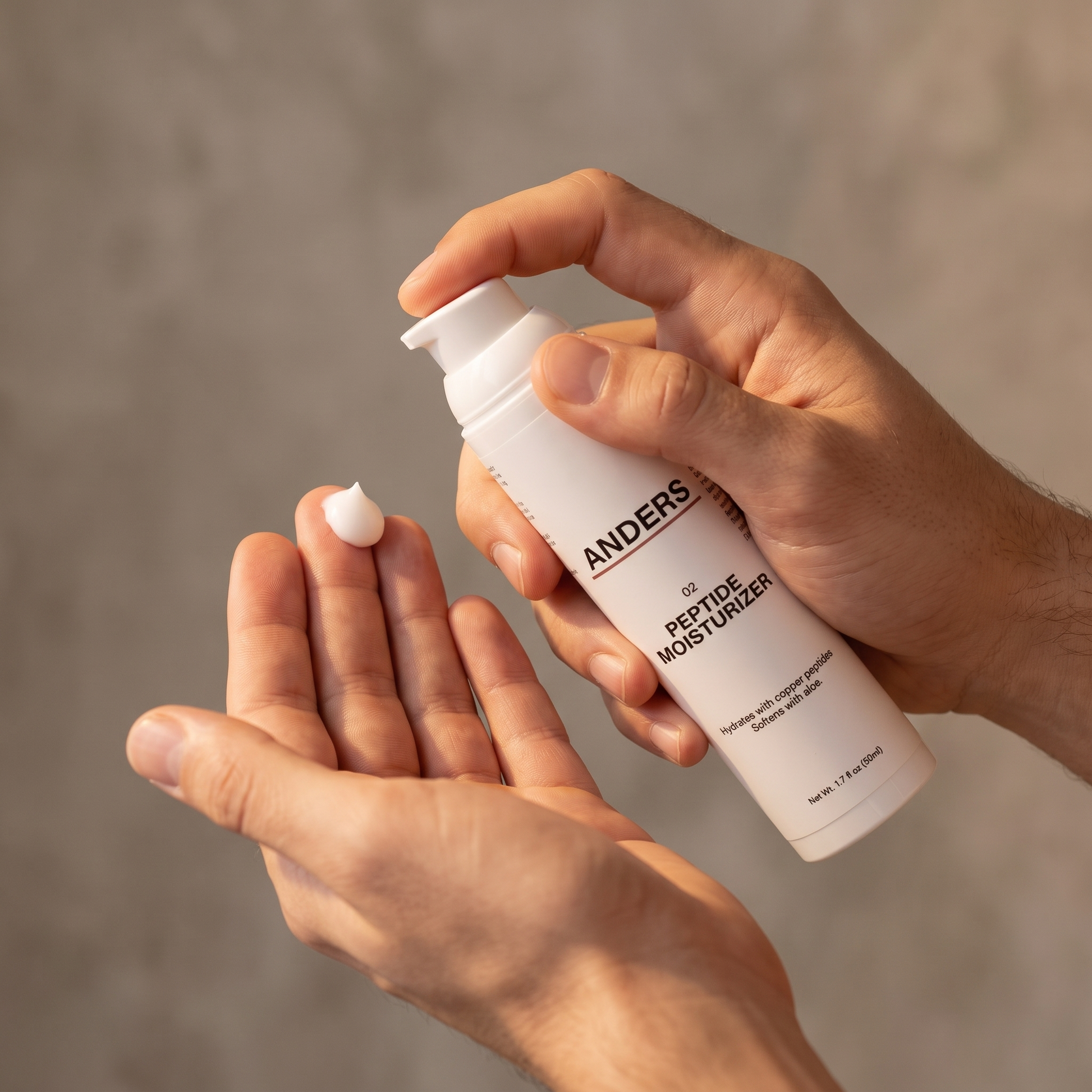 Pressing one pump of ANDERS Peptide Moisturizer onto fingertips